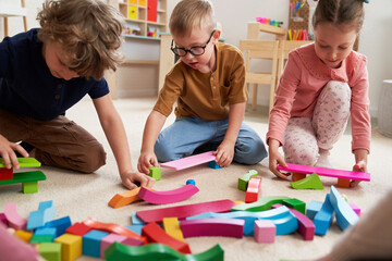Children playing with toy blocks in the kindergarten