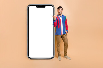 Full body photo of businessman marketing specialist promoting his google adsense stats at phone display isolated on beige color background