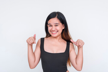 Young Asian woman in a black bodysuit giving thumbs up, isolated on white