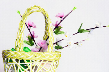 Straw basket with some flowering branches inside. Painting effect isolated on white for conceptual...