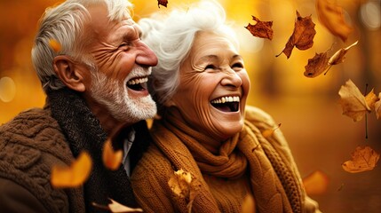 A couple of older people are laughing and smiling in the fall