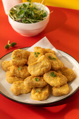 Fast food chicken nuggets paired with a glass of apple juice