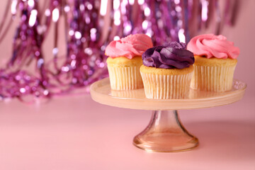 Delicious cupcakes with bright cream on pink background, space for text