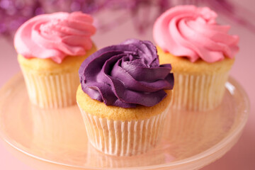 Delicious cupcakes with bright cream on table, closeup