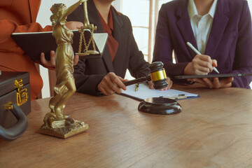 A group of lawyers and clients engage in a professional meeting at a law office, discussing agreements, contracts, and legal matters with a focus on justice and expert advice.