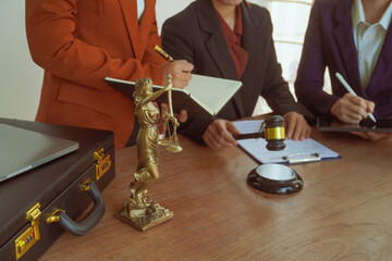 A group of lawyers and clients engage in a professional meeting at a law office, discussing...