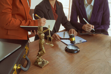 A group of lawyers and clients engage in a professional meeting at a law office, discussing...