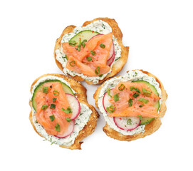 Tasty canapes with salmon, cucumber, radish and cream cheese isolated on white, top view