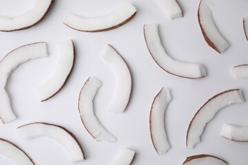 Pieces of fresh coconut on white background, top view