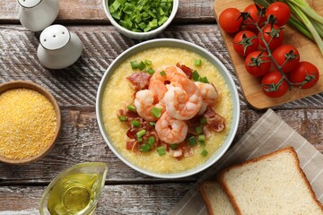 Fresh tasty shrimps, bacon, grits and green onion in bowl on wooden table, flat lay