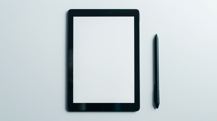 Tablet with a blank screen and stylus pen on a white surface.
