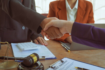 Shakinghands  A group of lawyers and clients engage in a professional meeting at a law office,...