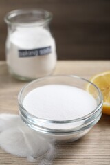 Baking soda and lemon on wooden table