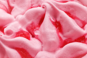 The macro of pink flavored ice cream with strawberry jam. The abstract creamy cold dessert for refreshment, closeup view.