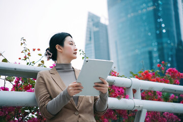 Professional Woman Using Tablet in Urban Garden Setting