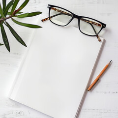 Blank white notepad, pencil and glasses on the table
