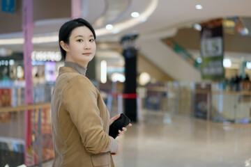 Confident Woman Posing in a Stylish Shopping Mall