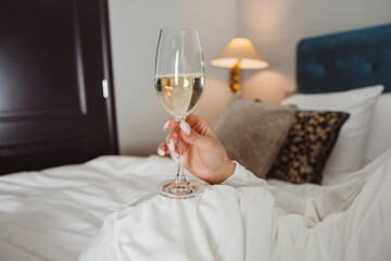 glass of champagne in female hands