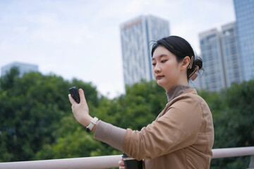Urban Woman Capturing the Moment with Smartphone