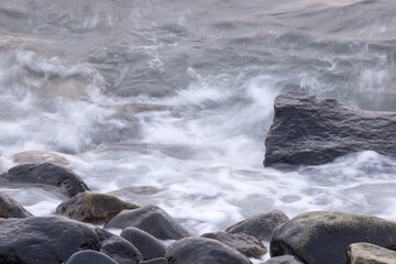 Ocean waves crashing on a rocky shore