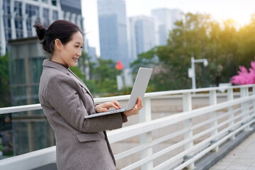 Professional Woman Working Outdoors on Laptop