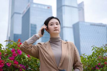 Businesswoman Making a Call in Urban Garden Setting