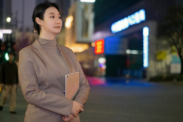 Confident Young Professional Woman in the City at Night