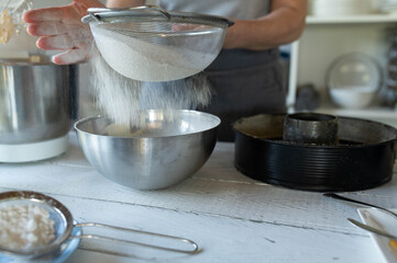 Sieving flour into a bowl for making batter