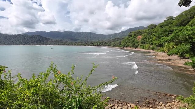 Stunning bay of Dominical. A pan over the surf beach Dominicalito. Paradise for surfers and nature lovers.