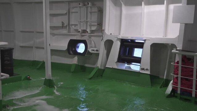 Ship in a storm. Water on closed mooring deck. Pitching. Sea through clew