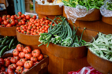 Vegetables on a market counter. Tomatoes, onions, peppers and cucumbers. High quality photo