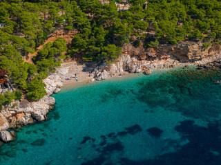 AERIAL: Hidden gem of a sandy beach in a remote part of a Mediterranean island. - obrazy, fototapety, plakaty