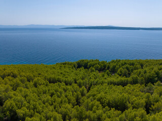 AERIAL: Flying over the pine forests of Hvar reveals the calm Adriatic sea.