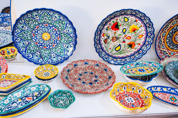 colorful Uzbek ceramic plates hand-painted at the oriental tableware store at the pottery workshop in Uzbekistan