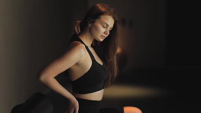 Attractive, slim, athletic girl, woman,  model posing in the gym sitting on a machine, stretching and beautiful body movements, sport, health, beauty, deep color and light, cool, luxury, lifestyle