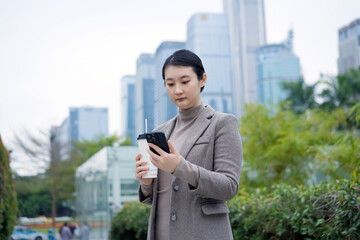 Professional Woman Using Smartphone in City Environment