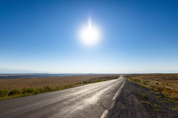 An asphalt road to the Horizon and the sun for the purpose of web and design use