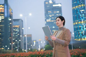 Confident Businesswoman Working on Tablet in Urban Setting