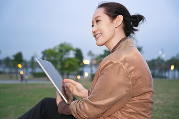Young Professional Enjoying Leisure Time with Tablet Outdoors