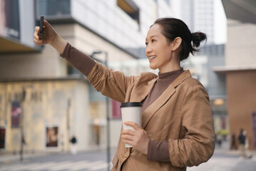 Urban Woman Enjoying Coffee and Taking Selfie