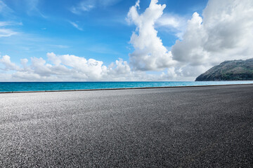 Asphalt road and blue sea with island nature landscape on a sunny day
