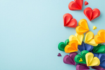 An artistic arrangement of colorful paper hearts in rainbow colors represents love and diversity...