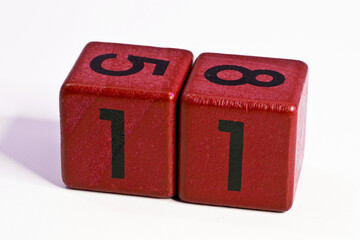 Number eleven written on a red wooden cube of a calendar date