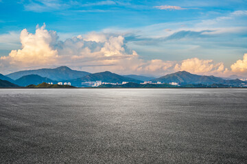 Asphalt road square and green mountain with sky clouds natural landscape at sunrise