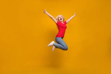 Full length body size photo woman jumping up shouting crazy isolated vibrant orange color background