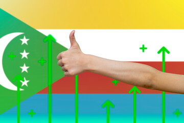 Comoros flag with green up arrows, increasing values and improving economy,  finger thumbs up front 