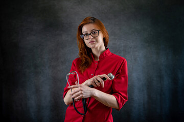  portrait of  female  nurse or general practitioner in red uniform with stethoscope