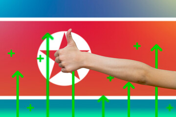 North Korea flag with green up arrows, country statistics concept,  finger thumbs up front of North 