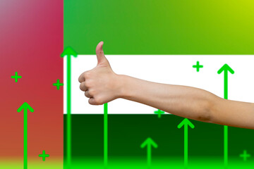 UAE flag with green up arrows, upward rising arrow on data,  finger thumbs up front of UAE flag