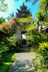 Bali ancient entrance stone gate surrounded with plants